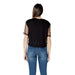 Woman wearing a Black T Shirt with Sheer Sleeves and Blue Jeans