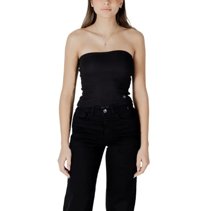 Woman wearing a black strapless top and matching black pants in the Striped Tube Top and Black Pants fashion set