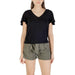 Woman wearing black V-neck flutter-sleeve top and green shorts in product display