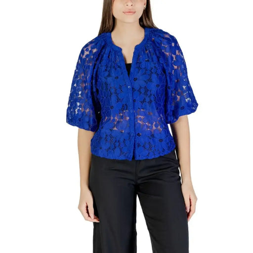 Woman wearing a stylish blue lace blouse in the Women’s Blue Lace Blouse product display