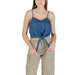 Woman wearing a blue tie-front tank top and khaki cargo pants demonstrating casual style