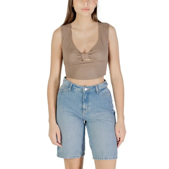 Woman wearing a brown crop top and denim shorts in the Women in Black Crop Top and Pants product image