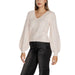Woman wearing a cream-colored V-neck sweater with balloon sleeves from the Women V Neck Sweater with Balloon Sleeves collection