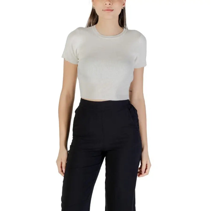 Woman wearing a black crop top and black pants from Womens Black Crop Top and Blue Denim Shorts collection