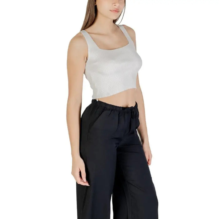 Woman wearing cropped tank top and black pants from Womens Cropped Tank Top and Black Pants collection