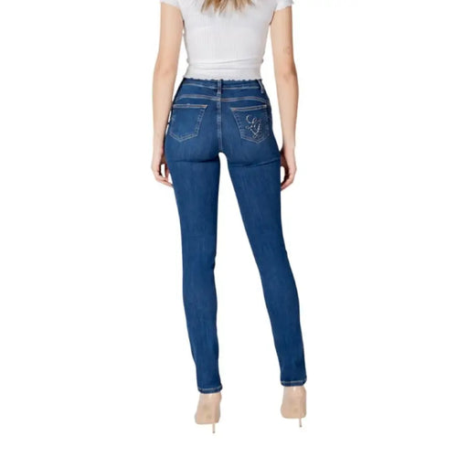 Woman’s dark wash blue denim skinny jeans featured in the product listing