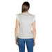 Woman wearing a gray ruffled-sleeve top and blue jeans showcasing a casual outfit