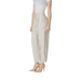 Woman’s high-waisted beige trousers featured in the Beige Pleated Trousers product