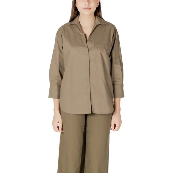 Woman wearing khaki-colored shirt and pants set from Orange Shirt and Pants Set collection