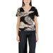 Woman wearing a leaf-patterned top and black pants from Womens Black V Neck Flutter Sleeve Top and Green Shorts collection