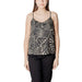 Woman wearing leaf-patterned camisole and black pants showcasing stylish comfort