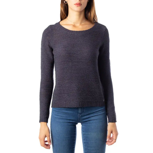 Woman’s long-sleeved white knit sweater with round neckline on display