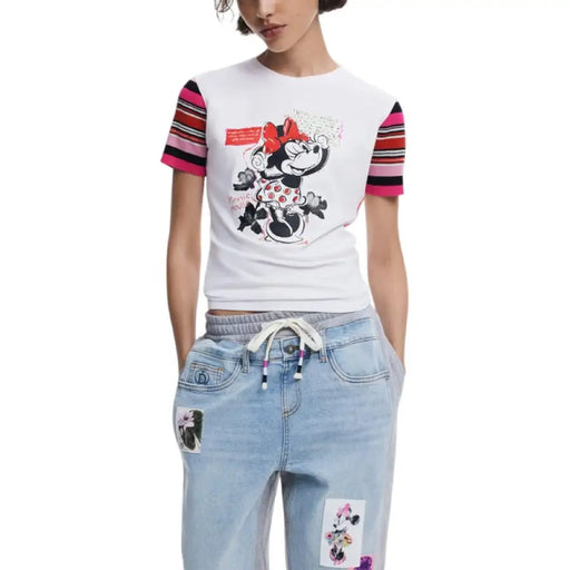 Woman wearing Minnie Mouse graphic tee and patchwork jeans showcasing casual style