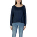 Woman wearing a navy blue long-sleeved sweater and jeans, showcasing Liu Jo T-shirt
