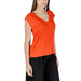Woman wearing an orange V-neck top for women in a product display image