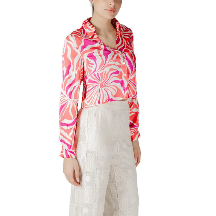 Woman wearing a patterned blouse and white lace pants for women, stylish outfit option