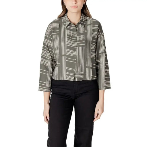 Woman wearing a stylish patterned button-down shirt from Womens Patterned Button Down Shirt collection