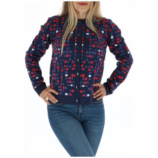 Woman wearing a patterned cardigan from the Women Patterned Sweater Cardigan and Jeans Collection