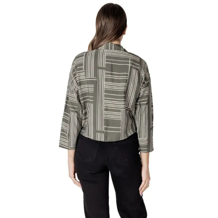 Woman wearing a patterned cropped blouse from Women’s Patterned Button Down Shirt collection