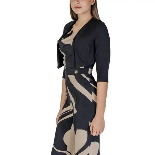 Woman in a patterned jumpsuit with a black bolero, featuring Rinascimento cardigan