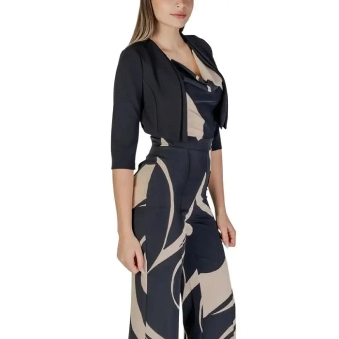 Woman’s patterned jumpsuit complemented by a black bolero from Rinascimento collection