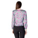 Woman wearing Rinascimento Women’s Green V-Neck Printed Blouse with patterned long sleeves