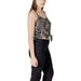 Woman wearing patterned tie-front tank top with black jeans, stylish women’s fashion ensemble