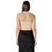 Woman wearing peach halter top and black skirt showcasing style and elegance