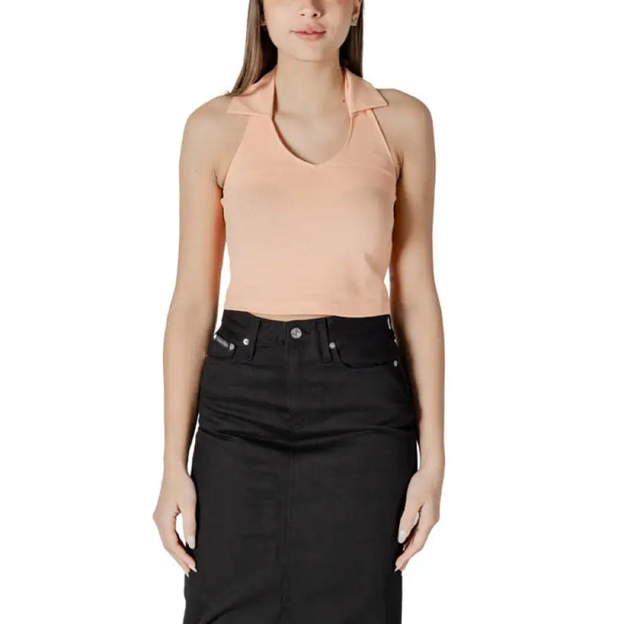 Woman wearing a peach halter top and black skirt displayed in Womens Peach Halter Top and Black Skirt product image