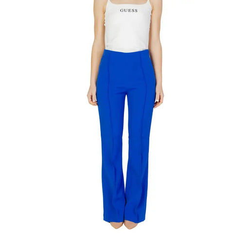 Royal blue high-waisted flare trousers with a white spaghetti strap tank top for women