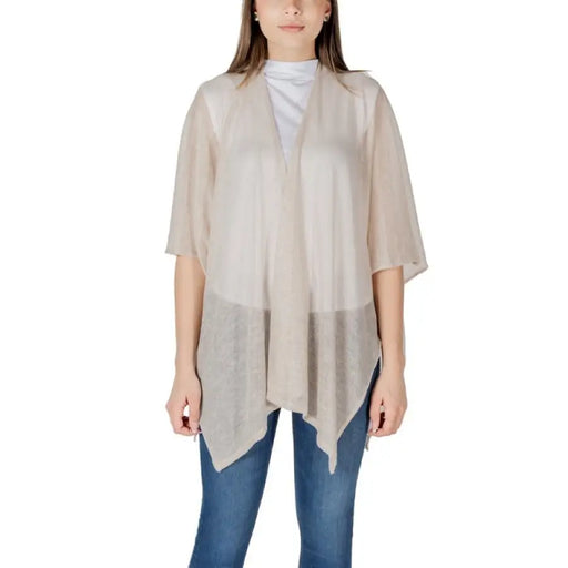 Woman wearing a sheer beige cardigan from the Women’s Beige Cardigans and Poncho Collection