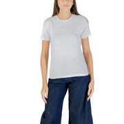 Woman wearing a white 100% cotton short sleeve round neck T-shirt and dark blue wide-leg jeans