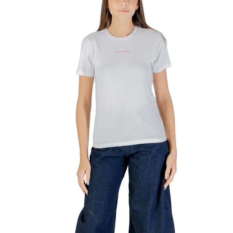 Woman wearing a white 100% cotton short sleeve round neck T-shirt and dark blue wide-leg jeans