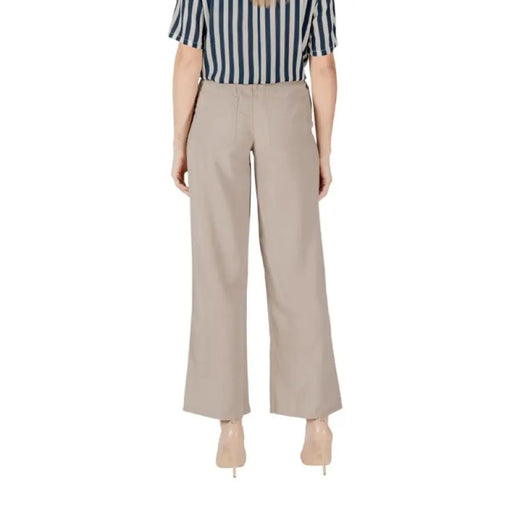 Woman’s striped shirt paired with Beige Wide Leg Pants for Women in a stylish outfit