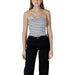 Woman wearing striped tube top and black pants shown in product listing