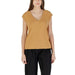 Woman wearing a tan V-neck top and black pants, showcased in the Orange V Neck Top for Women product image