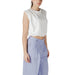 Woman wearing a white crop top and blue pants showcasing the White Crop Top and Blue Pants for Women