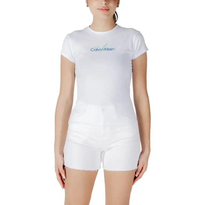 Woman wearing white Calvin Klein T shirt and shorts outfit, casual summer attire