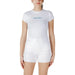 Woman wearing white Calvin Klein T shirt and shorts outfit, casual summer attire