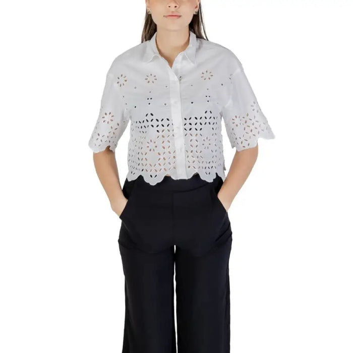 Woman wearing white eyelet shirt and black pants from Women’s Black Eyelet Shirt and Denim Shorts collection