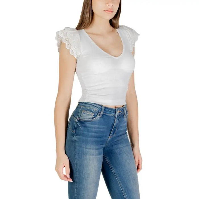 Woman wearing a white lace-trimmed top and blue jeans in the White Top and Blue Jeans for Women collection