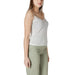 Woman wearing white lace-trimmed camisole and green pants for Women’s White Lace Trim Camisole and Green Pants product