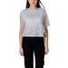 Woman wearing a white sheer-sleeved top paired with black pants, showcasing a stylish outfit