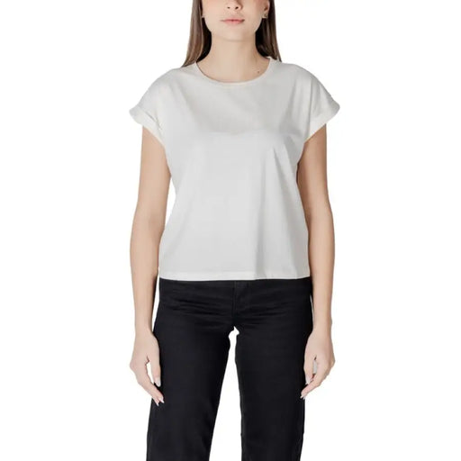 Woman wearing Liu Jo Black T Shirt and white pants showcasing casual style