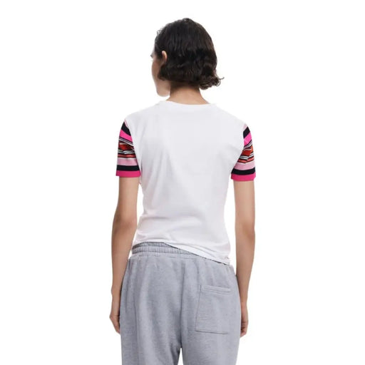 Woman wearing a white T-shirt with striped sleeves from Womens Minnie Mouse Graphic Tee and Patchwork Jeans collection