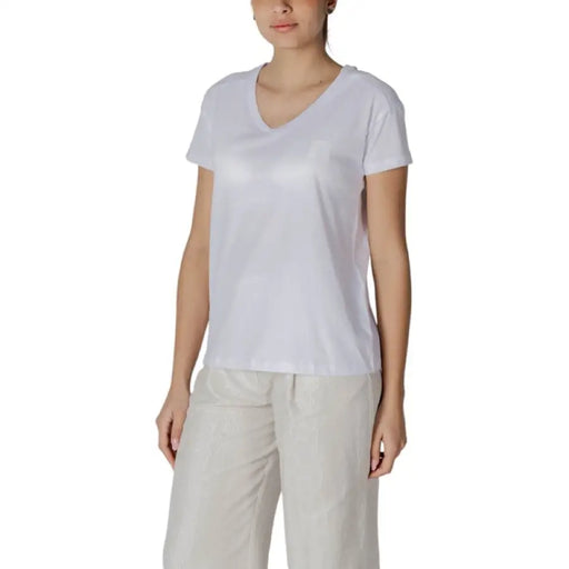 Woman wearing a white V-neck T-shirt, product named Womens White V Neck T Shirt