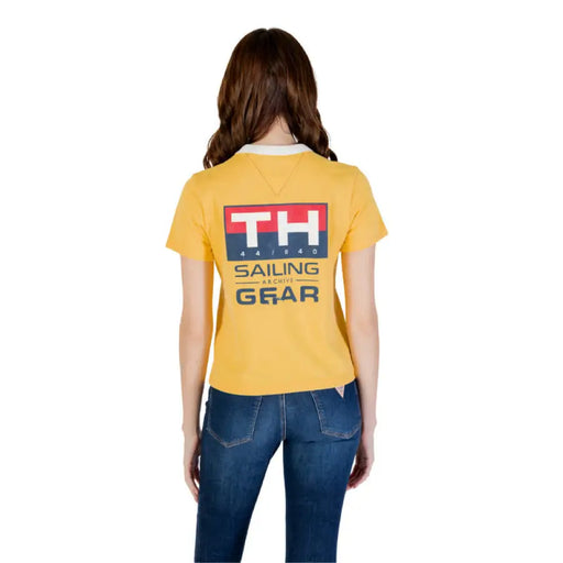 Woman wearing a yellow T shirt with graphic and white collar for women’s fashion