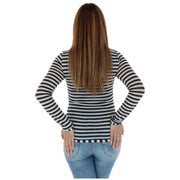 A woman wearing a women striped long sleeve shirt with black and white horizontal stripes and anchor embellishment