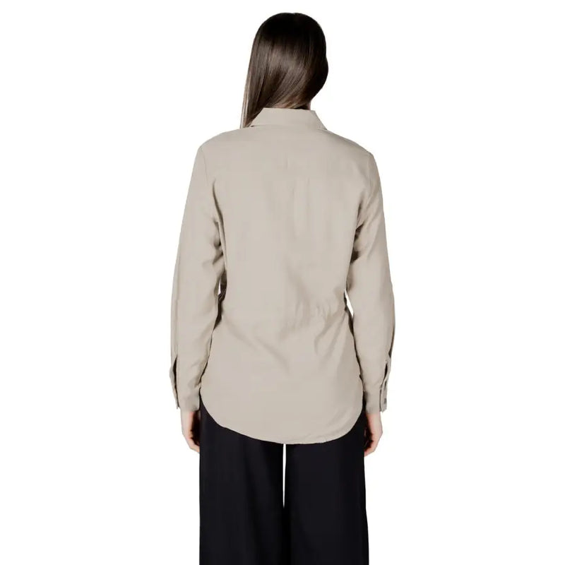 Womens beige button down drawstring blazer shown from the back with long sleeves classic collar and subtle pleats