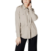 Womens beige button down blazer with long sleeves, chest pockets, and a drawstring waist in soft fabric